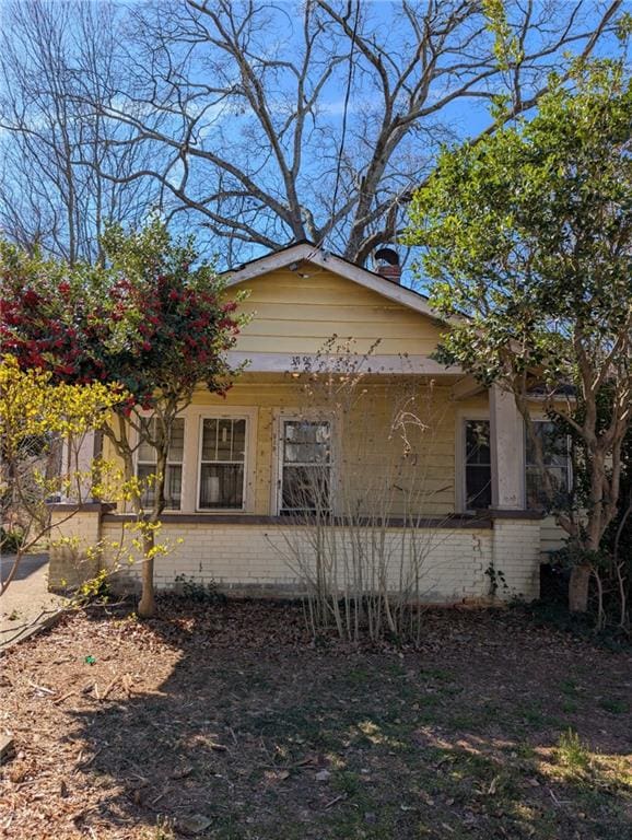 view of side of property with brick siding