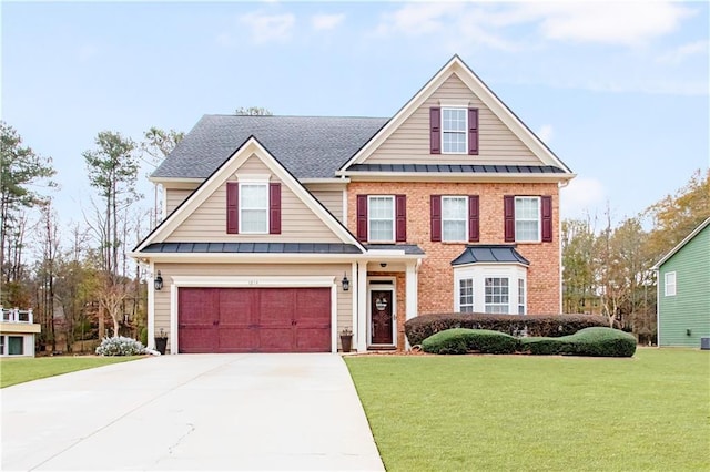 view of front of house with a garage and a front lawn