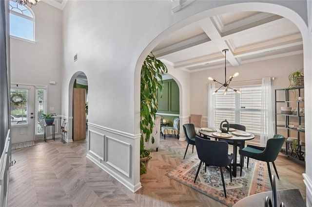 7530 Springbox Dr, Fairburn, GA 30213 - dining space with a chandelier, crown molding, beamed ceiling, coffered ceiling, and arched walkways