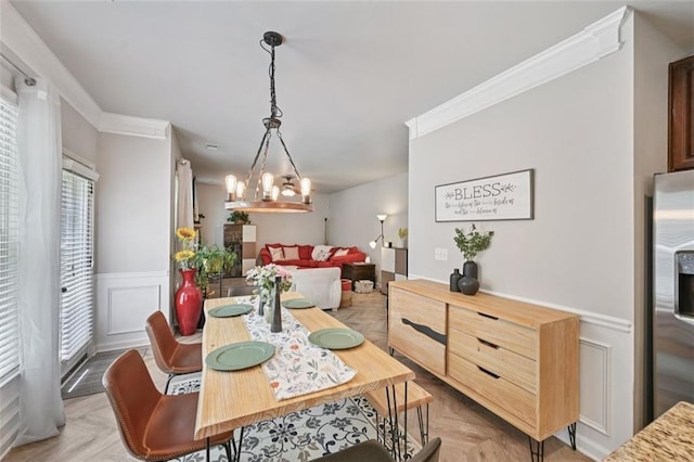 7530 Springbox Dr, Fairburn, GA 30213 - dining area with a decorative wall, a chandelier, ornamental molding, and wainscoting
