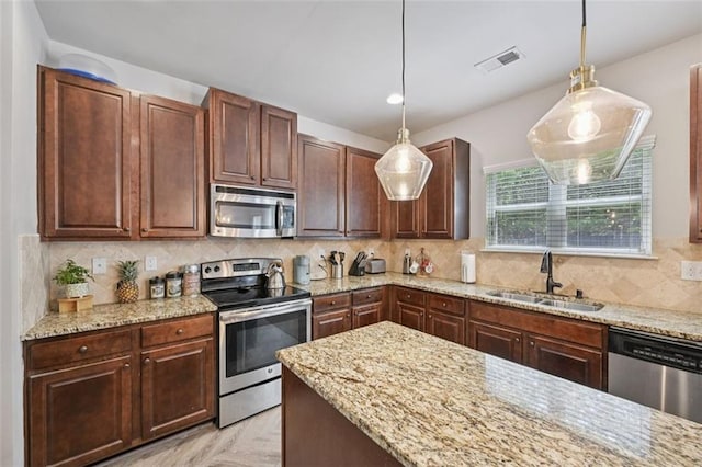 7530 Springbox Dr, Fairburn, GA 30213 - kitchen featuring stainless steel appliances, light stone countertops, pendant lighting, and backsplash