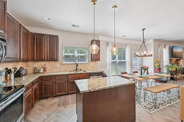 7530 Springbox Dr, Fairburn, GA 30213 - kitchen featuring light stone counters, tasteful backsplash, stainless steel appliances, dark brown cabinetry, and recessed lighting