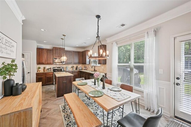 7530 Springbox Dr, Fairburn, GA 30213 - dining space featuring a wainscoted wall, a chandelier, ornamental molding, and recessed lighting