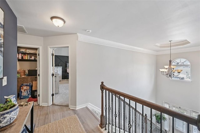 7530 Springbox Dr, Fairburn, GA 30213 - hallway with an upstairs landing, light wood-style flooring, a chandelier, and crown molding