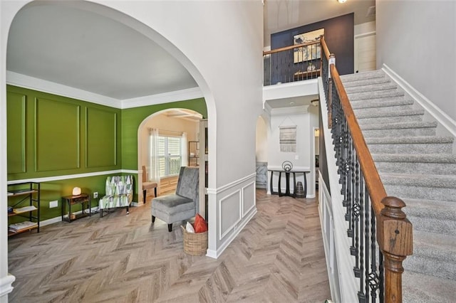 7530 Springbox Dr, Fairburn, GA 30213 - stairway with arched walkways, ornamental molding, wainscoting, and a towering ceiling
