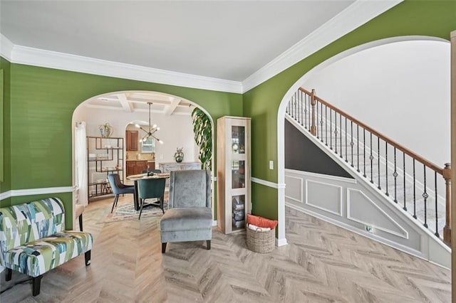 7530 Springbox Dr, Fairburn, GA 30213 - living area featuring arched walkways, crown molding, stairway, and a chandelier