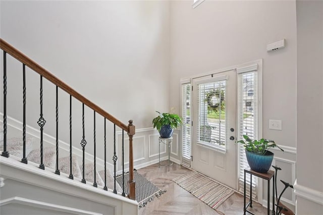 7530 Springbox Dr, Fairburn, GA 30213 - entrance foyer with a decorative wall, stairway, a wainscoted wall, and a towering ceiling