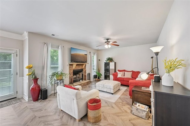 7530 Springbox Dr, Fairburn, GA 30213 - living room with healthy amount of natural light, a ceiling fan, and a stone fireplace