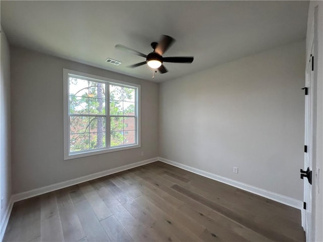 empty room with ceiling fan and dark wood-type flooring