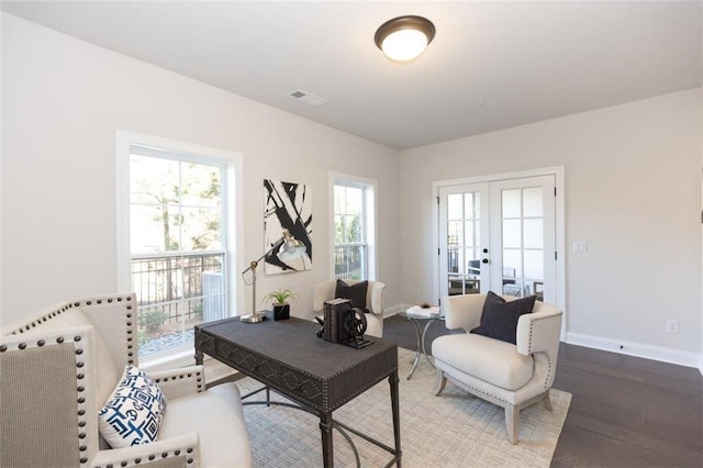 sitting room with hardwood / wood-style floors, french doors, and a healthy amount of sunlight