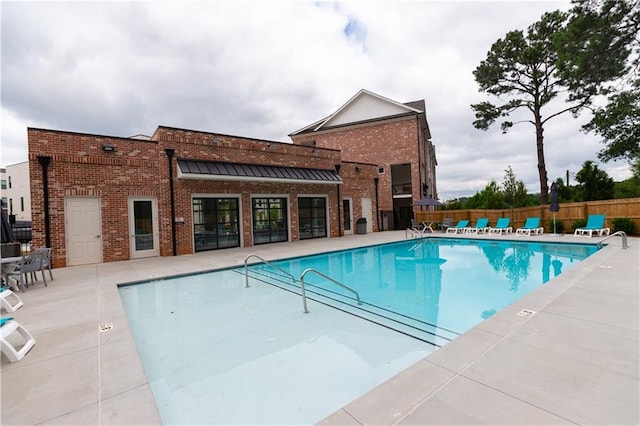 view of swimming pool with a patio