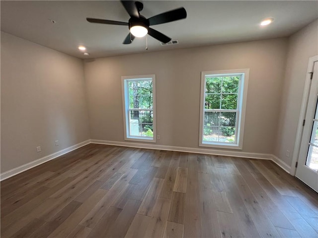 spare room with ceiling fan and dark wood-type flooring