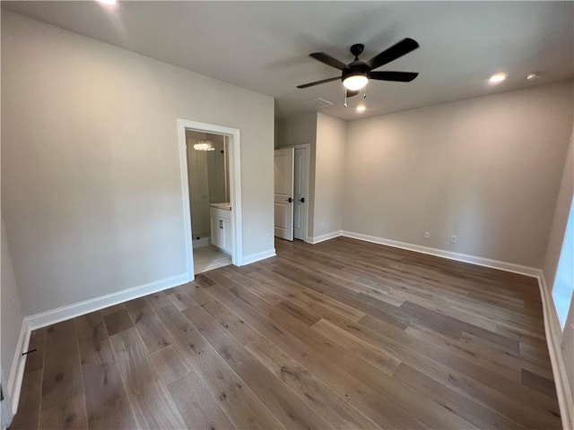 spare room with ceiling fan and dark hardwood / wood-style flooring