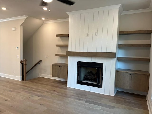 unfurnished living room with crown molding, dark hardwood / wood-style flooring, a fireplace, and ceiling fan