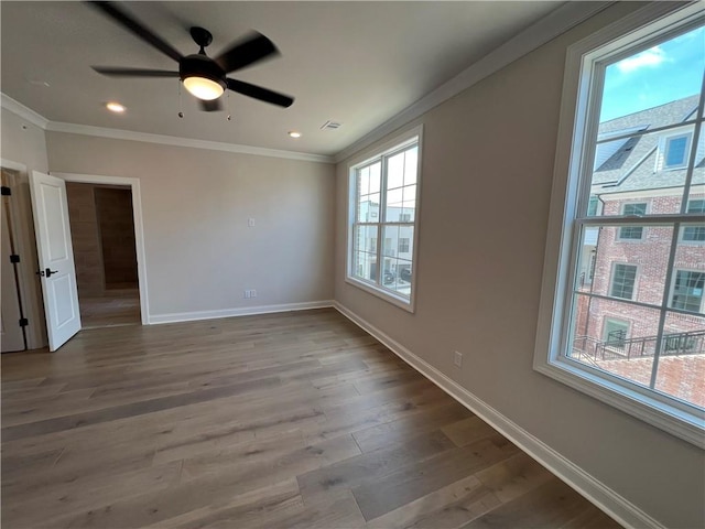 spare room featuring ceiling fan, ornamental molding, and hardwood / wood-style floors