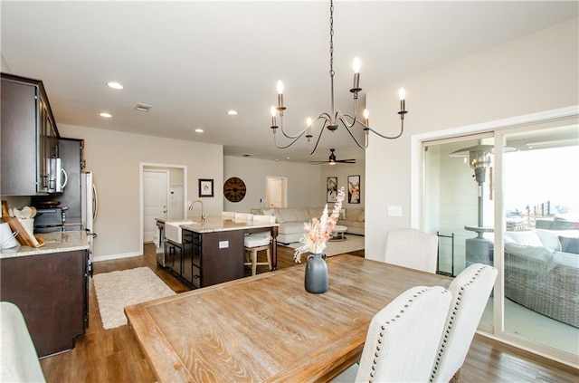 dining area with dark wood-style floors, visible vents, recessed lighting, and a ceiling fan