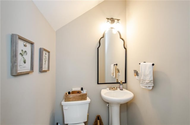 bathroom featuring toilet and vaulted ceiling