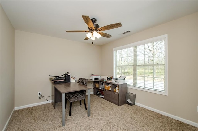 office space with visible vents, a ceiling fan, baseboards, and carpet floors