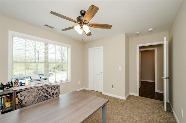 home office with visible vents, carpet flooring, baseboards, and ceiling fan