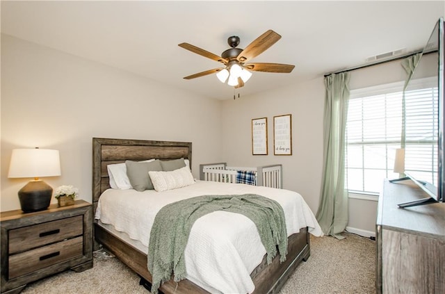 bedroom featuring ceiling fan, baseboards, and light carpet