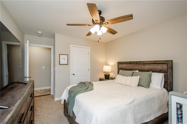 bedroom featuring baseboards, light colored carpet, and ceiling fan