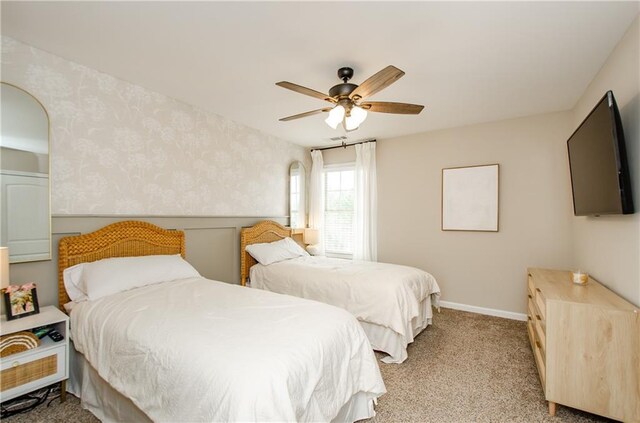 carpeted bedroom with baseboards, ceiling fan, and wallpapered walls