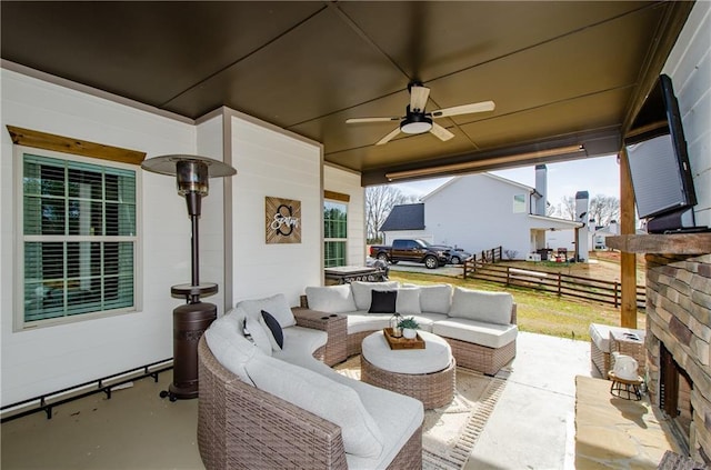 view of patio / terrace with an outdoor hangout area, ceiling fan, and fence