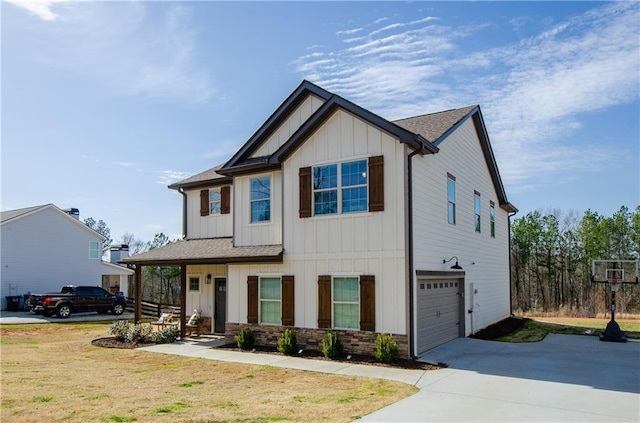 view of front of house featuring stone siding, an attached garage, board and batten siding, and driveway