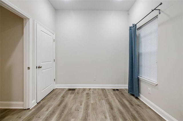 spare room featuring light hardwood / wood-style floors