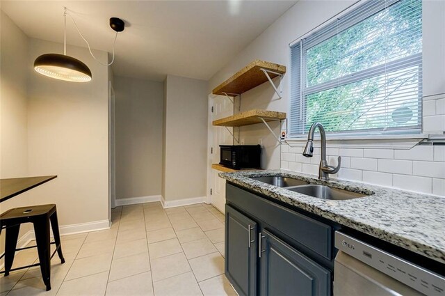 kitchen with light stone counters, light tile patterned floors, backsplash, stainless steel dishwasher, and sink