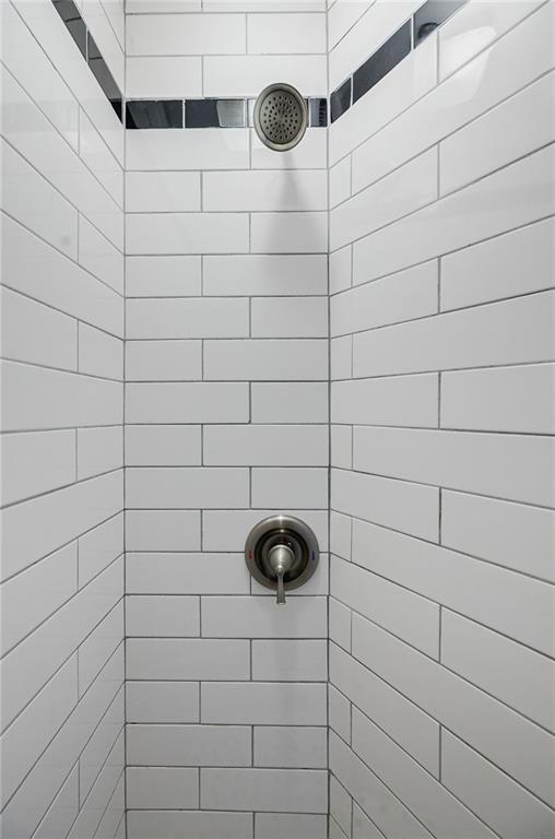 bathroom with tiled shower