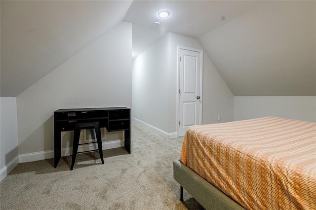 carpeted bedroom with lofted ceiling