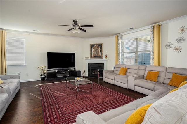 3469 English Elm Way, Loganville, GA 30052 - living room featuring baseboards, visible vents, a glass covered fireplace, ceiling fan, and wood finished floors