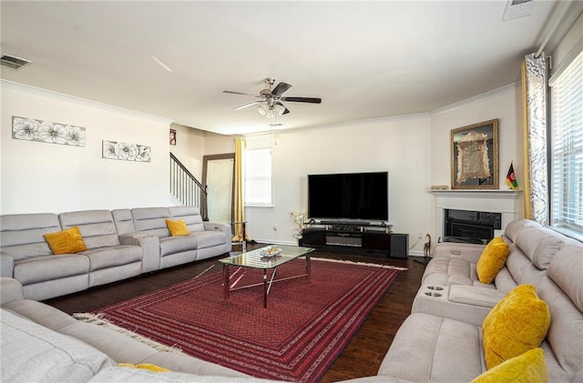3469 English Elm Way, Loganville, GA 30052 - living area with crown molding, wood finished floors, a glass covered fireplace, visible vents, and ceiling fan