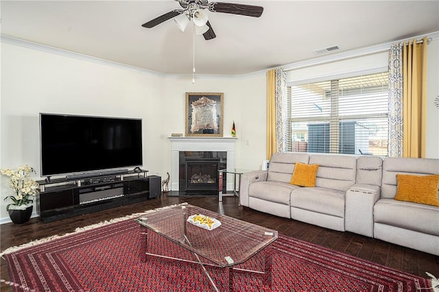 3469 English Elm Way, Loganville, GA 30052 - living area with visible vents, a tile fireplace, crown molding, ceiling fan, and wood finished floors