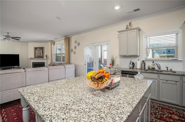 3469 English Elm Way, Loganville, GA 30052 - kitchen featuring gray cabinets, a kitchen island, a sink, visible vents, and a ceiling fan