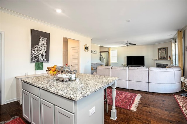 3469 English Elm Way, Loganville, GA 30052 - kitchen with a ceiling fan, a center island, crown molding, and dark wood finished floors