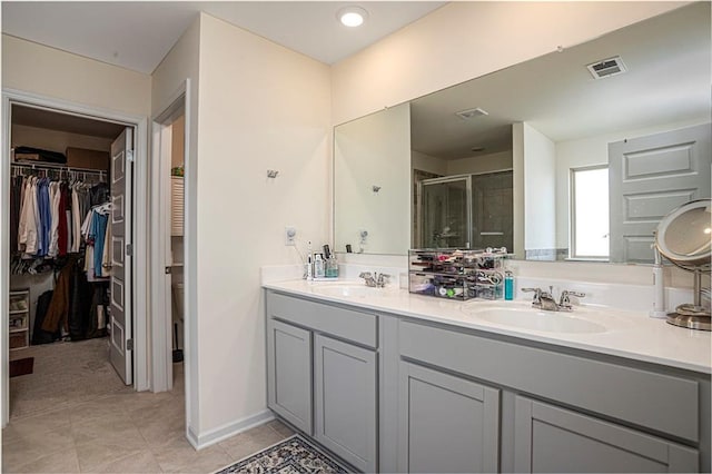 3469 English Elm Way, Loganville, GA 30052 - bathroom featuring visible vents, a sink, double vanity, and a shower stall