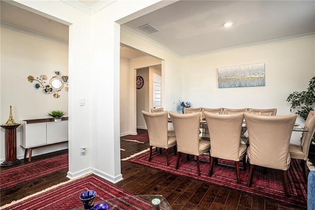 3469 English Elm Way, Loganville, GA 30052 - dining room featuring baseboards, visible vents, ornamental molding, and wood-type flooring