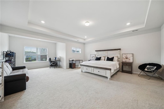 carpeted bedroom with recessed lighting, visible vents, and a raised ceiling