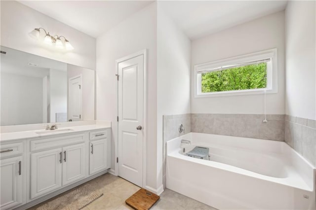 full bath featuring tile patterned floors, a garden tub, and vanity