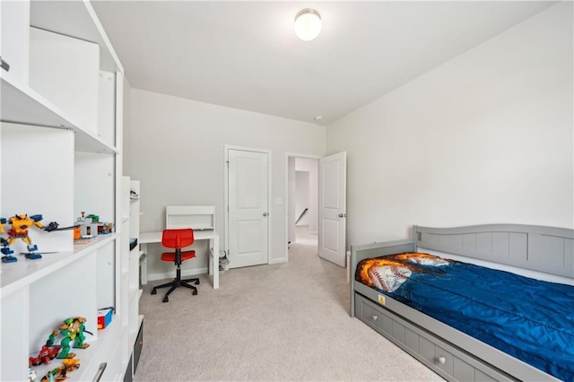 bedroom with baseboards and light carpet