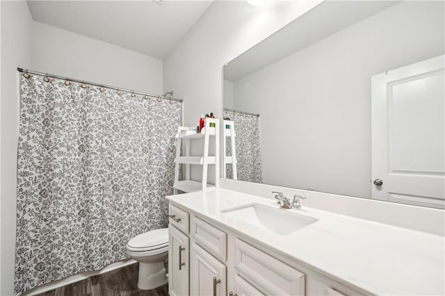 full bath featuring vanity, wood finished floors, and toilet