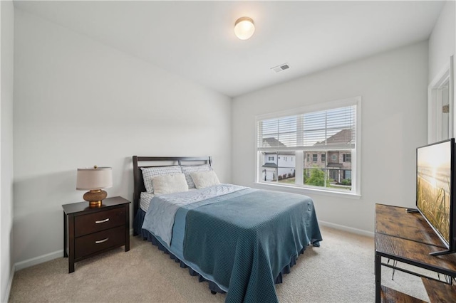 bedroom featuring baseboards, light colored carpet, and visible vents