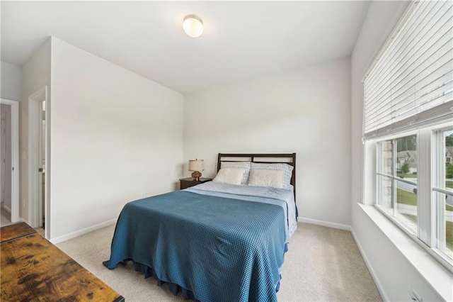 bedroom with carpet floors and baseboards
