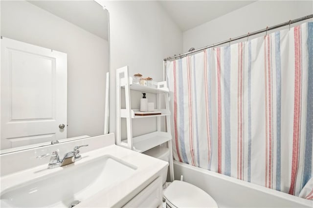 bathroom with toilet, shower / bath combo, and vanity