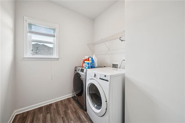 washroom with baseboards, laundry area, dark wood finished floors, and washing machine and clothes dryer