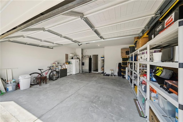 garage featuring freestanding refrigerator and stainless steel fridge