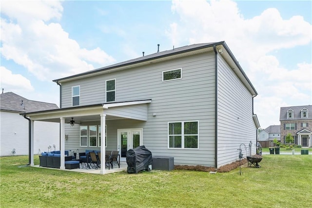 back of house with a patio, a ceiling fan, outdoor lounge area, and a yard