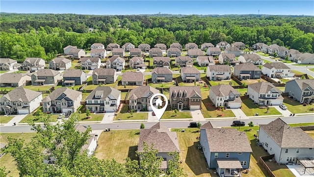 aerial view featuring a wooded view and a residential view